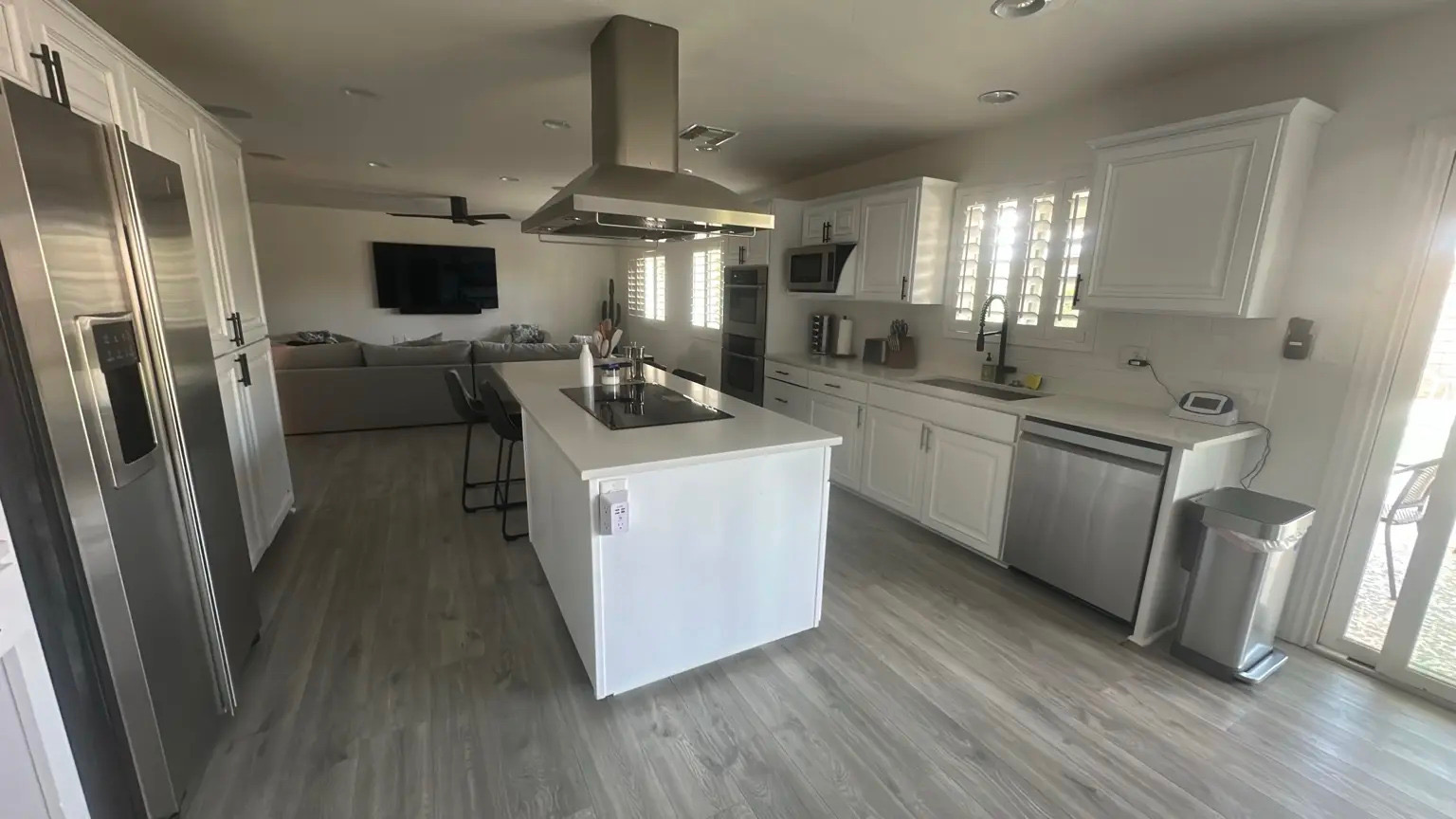 Bright white kitchen and open living space cleaned by Handy Girlz in Phoenix, AZ