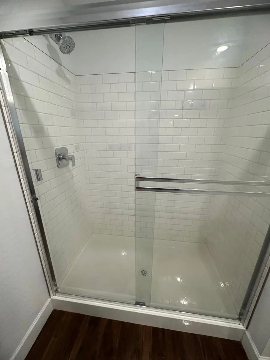 Sparkling clean tiled shower after a Handy Girlz deep cleaning